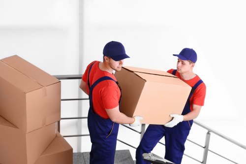Packed moving boxes and furniture prepared for transport by removals staff