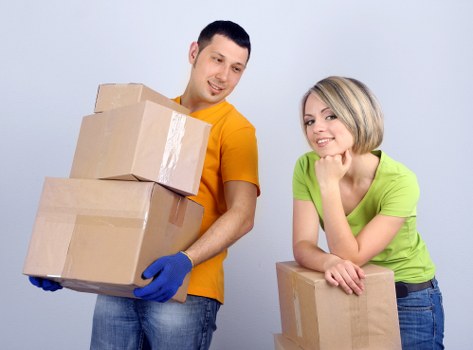 Professional movers loading office furniture in central London