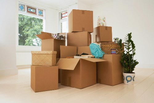 Professional office movers handling furniture in a central London office move