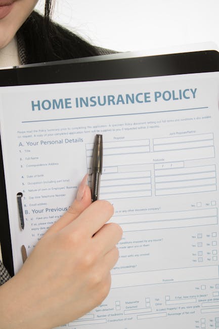 A person holding a silver pen and preparing to fill out a home insurance policy form titled 'HOME INSURANCE POLICY' with fields for personal details, previous insurance information, and other relevant data. The form is placed on a clipboard, and part of the person's black hair and white shirt are visible. The background is plain white, emphasizing the paperwork process. This image relates to documentation and preparation for home relocations, reflecting the importance of insurance in moving services. The setting appears to be indoors, with good lighting focusing on the form and hand, aligning with professional and reliable moving and packing practices promoted by Removal Companies Marylebone.